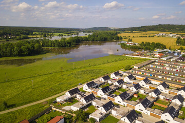 Aerial view of flooded Radbuza river near new family houses in city Dobrany. West Bohemia, Czech...