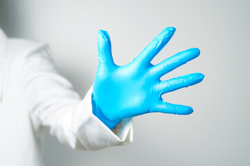 hand gestures or signs in blue disposable latex surgical gloves isolated