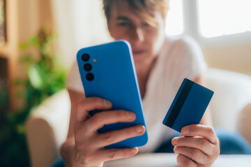 Woman Holding Credit Card and Phone for Digital Purchase. Online Payment Concept with Smartphone and Credit Card