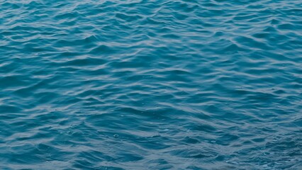 deep blue sea water background structure on the sunset