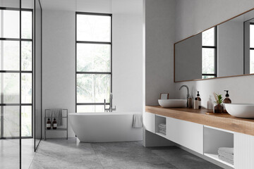 White bathroom interior with double sink and bathtub, panoramic window