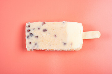 top view milkshake flavor popsicle with red beans on pink background