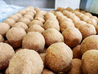 Traditional indian sweets of besan laddu or ladoo dessert or mithai arranged display pattern