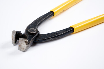 Nippers with yellow plastic handle on an isolated background