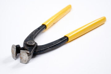 Nippers with yellow plastic handle on an isolated background