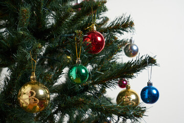 Detail of a Christmas tree with lights on isolated white background.