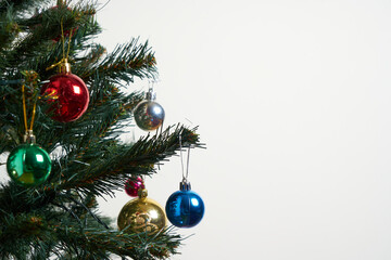 Detail of a Christmas tree with lights on isolated white background.