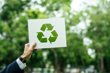 Businessman holding a sign recycle reuse reduce on nature background for zero waste concept and...