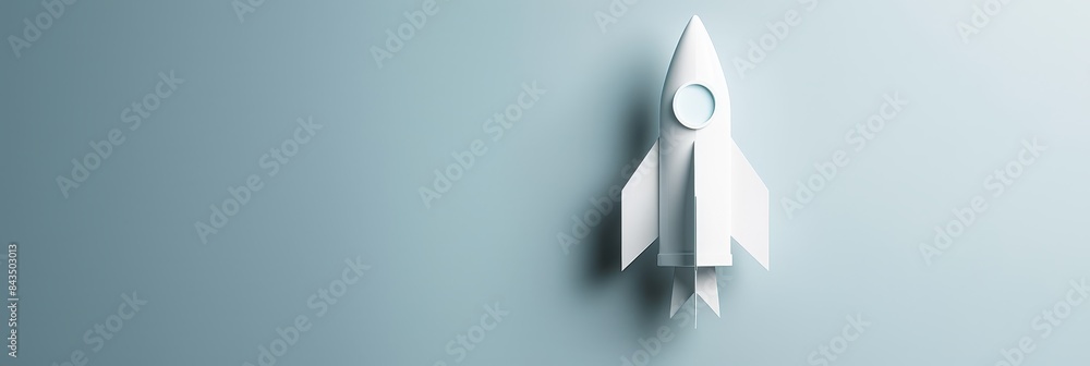 Poster paper rocket on a serene blue backdrop - a vertically-aligned white paper rocket centered on a seren