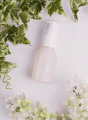 Unlabeled bottle of cosmetic or soap shower gel is displayed on an artistic background, product enclosure for liquid product for promotional