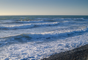 sea ​​foam on the waves of the Mediterranean sea on a summer evening in Cyprus