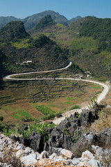 A scenic view of a curved dirt road leading to Meo Vac, a trip through the HA GIANG loop, Vietnam