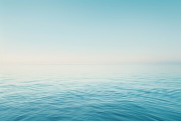 Obraz premium Serene ocean scene with calm waters and a clear blue sky, perfect for conveying tranquility and peacefulness.