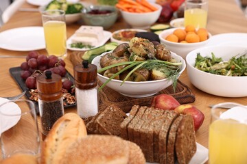 Healthy vegetarian food and glasses of juice on wooden table