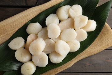 Fresh raw scallops on wooden table, top view