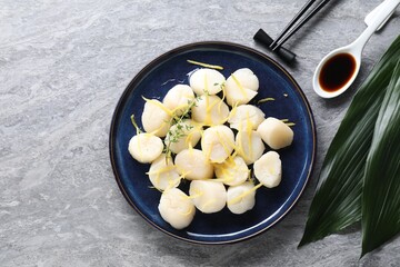 Raw scallops with thyme and lemon zest served on grey marble table, flat lay. Space for text