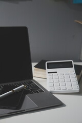 Flat lay, top view office table desk. Workspace with calculator,pen,laptop on white background.Copy Space for text,Empty Blank to word.Business Finance,Education Technology.Work from home.