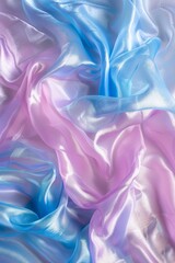 Fototapeta premium Luxurious waves of satin fabric displaying pink and blue tones, suitable for a high-end fashion concept