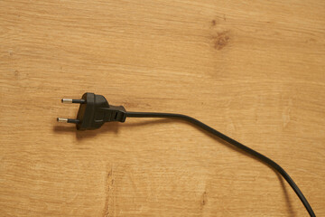 Black electrical euro plug on a table