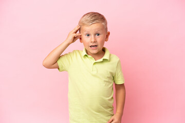 Little Russian boy isolated on pink background with surprise and shocked facial expression