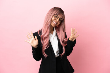 Young business mixed race woman with pink hair isolated on pink background counting nine with...