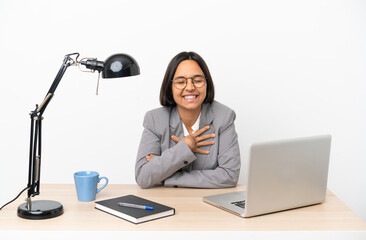 Young business mixed race woman working at office smiling a lot