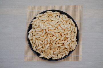 telur gabus sticks in black plate on wooden table background.