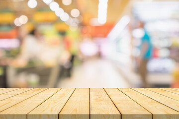 Empty wood table top with supermarket blurred background for product display