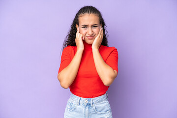 Young woman isolated on purple background frustrated and covering ears