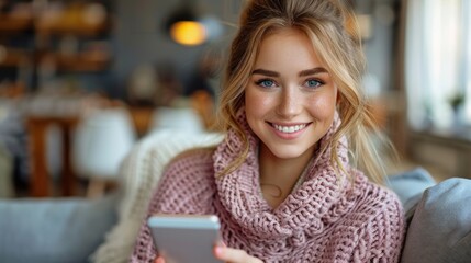 Woman smiles while looking at her smartphone