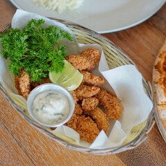 Fish and chips with white sauce in the basket