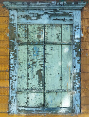 Old wooden window with closed shutters