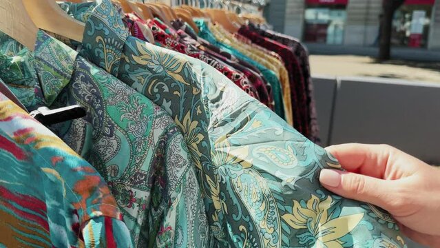 Close up shot of shirts in eco friendly second hand store.