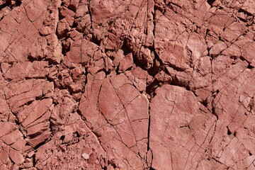 Close up of cracked red sandstone in all sort of patterns.  