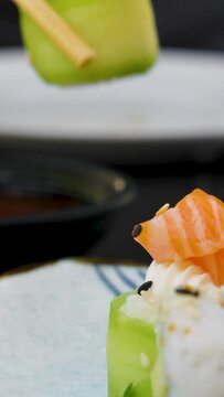 Eating sushi at a restaurant with chopsticks