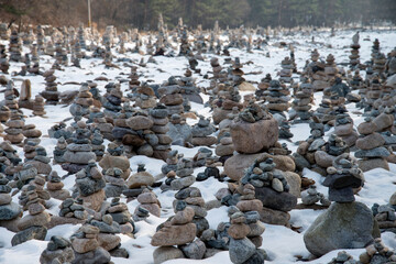 The tower of pebble stack on the side of stream