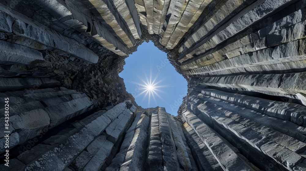 Poster a striking symmetrical shot of the basalt columns with the sun perfectly aligned in the middle creat
