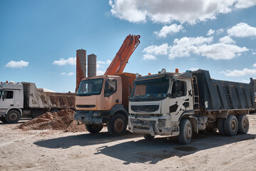 Dump trucks at construction site. Parked tipper trucks