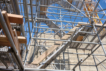 Low angle view of industrial stair tower and scaffoldings at construction site