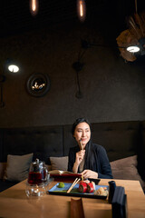 Young writer working on future bestseller in asian restaurant