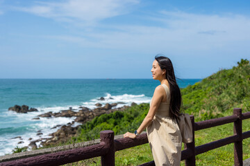 Travel woman look at the sea at summer time