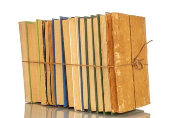 Several books tied with a rope, close-up on a white background.