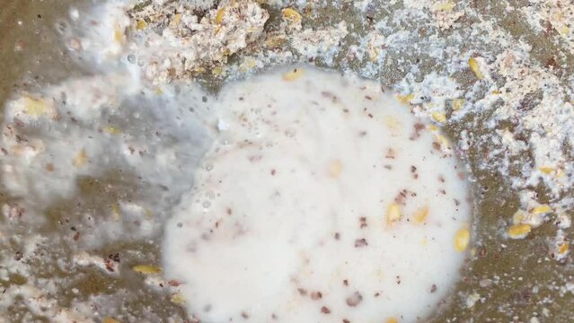 Making Thandai Sardai milk festival food by crushing almonds, Cantaloupe melon seeds summer drink