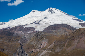 Snowy peak of Mount Elbrus in spring. Caucasus mountains. Kabardino-Balkaria Reublic. Panorama of...