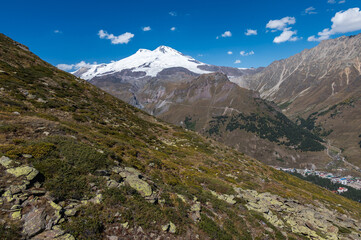 Snowy peak of Mount Elbrus in spring. Caucasus mountains. Kabardino-Balkaria Reublic. Panorama of Elbrus.