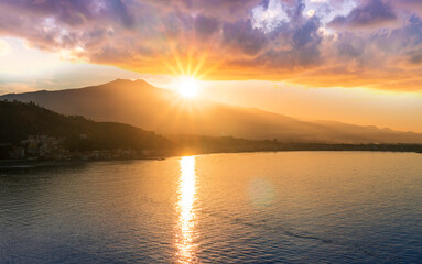 picturesque view to a sunset sea gulf with beautiful mountains and amazing cloudy sky on background of nice travel landscape