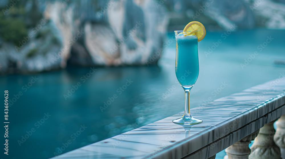 Poster a cerulean mocktail with a layer of bubbles and a slice of lemon. perched in a stylish flute on the 