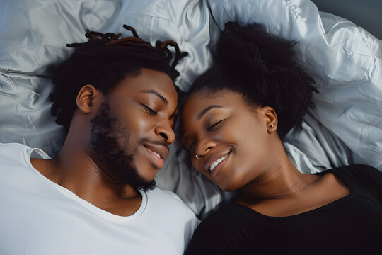 Black couple and eye contact in bed with romance for love with tender, embrace and care in morning with smile. Dating, relationship and relaxing with passion for partner with comfort or waking up.