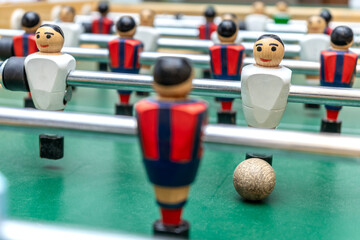CLOSE UP OF A FOOSBALL TABLE MATCH. SPORT BETS IN BETTING SHOPS.