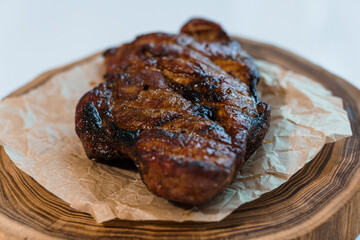 Pork steak with sauce on a wooden board